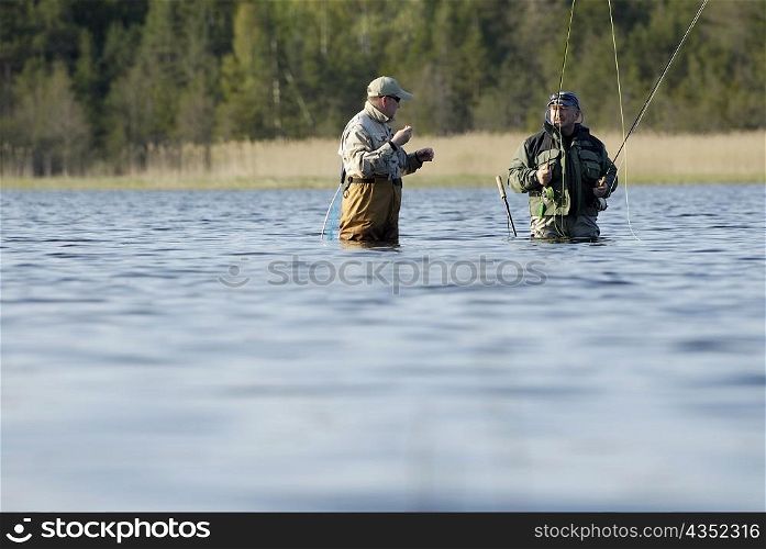 Two mature men fishing in the river