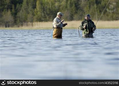 Two mature men fishing in the river