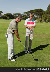Two mature men playing golf together