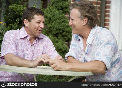 Two mature men talking together