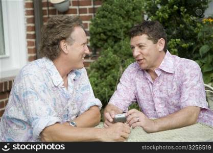 Two mature men talking together