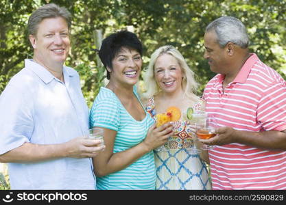 Two mature women holding glasses of martini and a mature man with a senior man holding glasses of wine