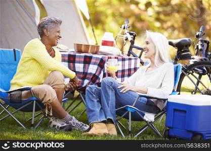 Two Mature Women Relaxing On Camping Holiday