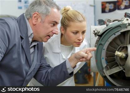 two mechanic engineers examining wheel