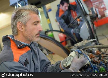 Two mechanics working in garage