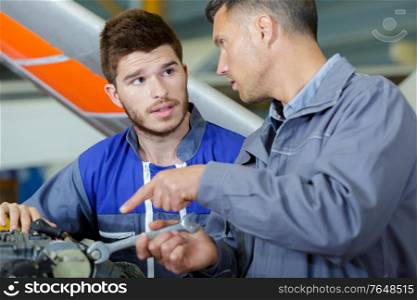 two mechanics working on an airplane