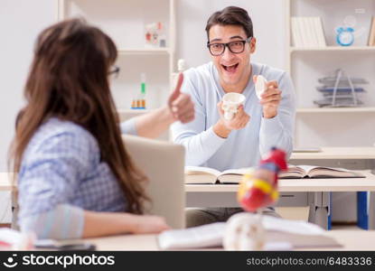 Two medical students studying in classroom