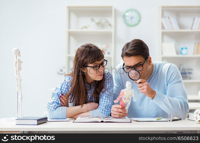 Two medical students studying in classroom