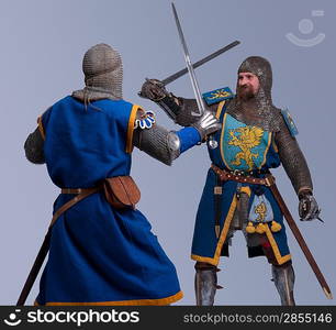 Two medieval knights fighting.