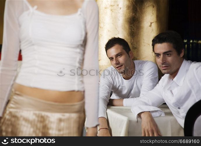 two men admiring woman&acute;s bottom