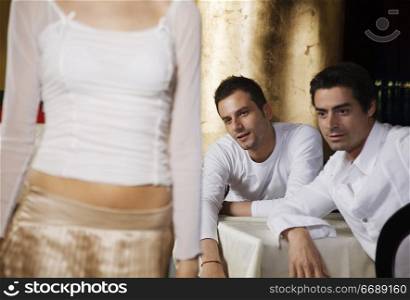 two men admiring woman&acute;s bottom