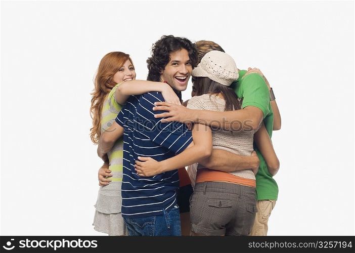 Two men and three young women making a huddle