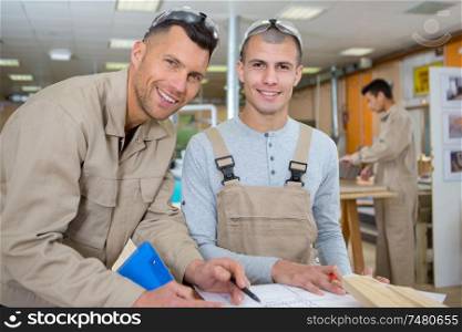 two men at work looking at camera