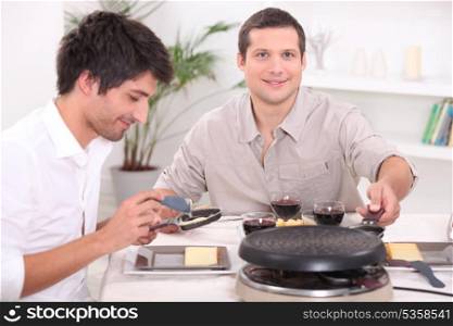 Two men enjoying a Raclette