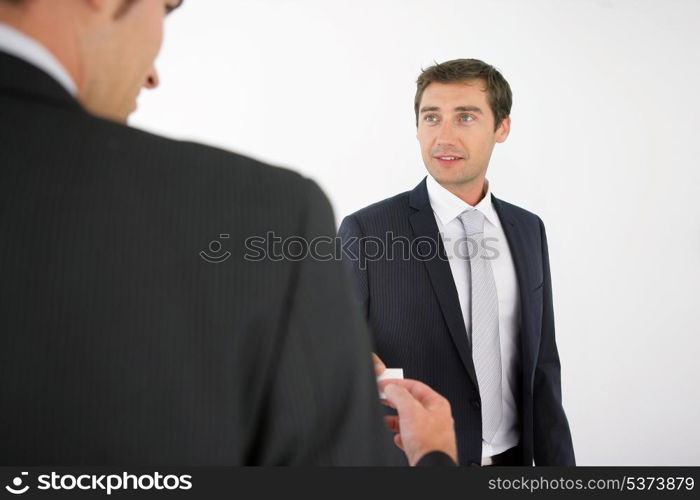 Two men exchanging business cards