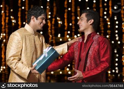 Two men exchanging gifts