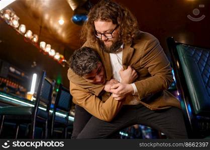 Two men fighting at sport bar for their favorite football team. Drunk people conflict. Soccer fans quarrel. Two men fighting at sport bar for their favorite football team