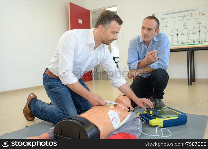 two men giving first aid lesson