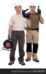 Two men holding power drills