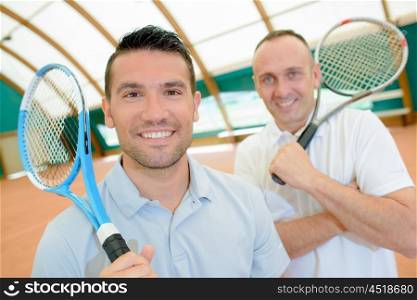 Two men holding tennis rackets