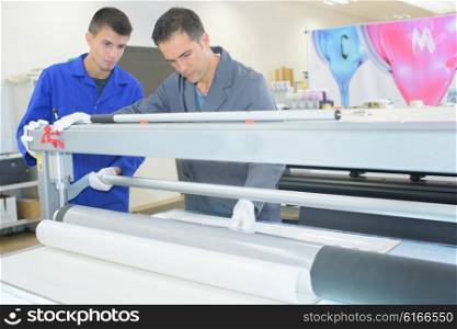 Two men in inductrial printing shop