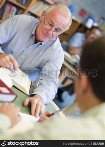 Two men in library with notepads talking (selective focus)