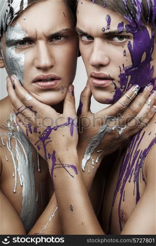 two men in silver and violet paint