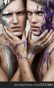two men in silver and violet paint