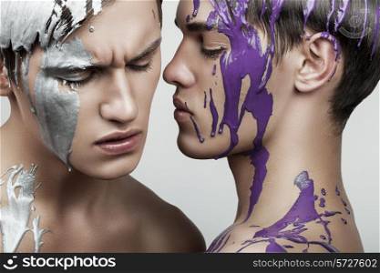 two men in violet and silver paint