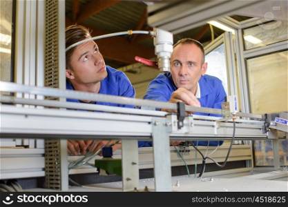 Two men looking at conveyor line