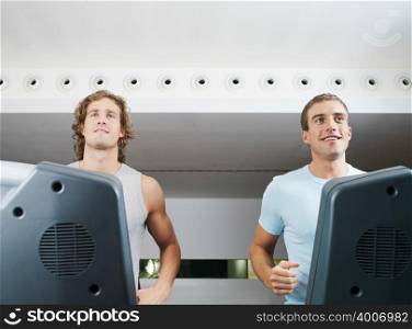 Two men on treadmill in health club