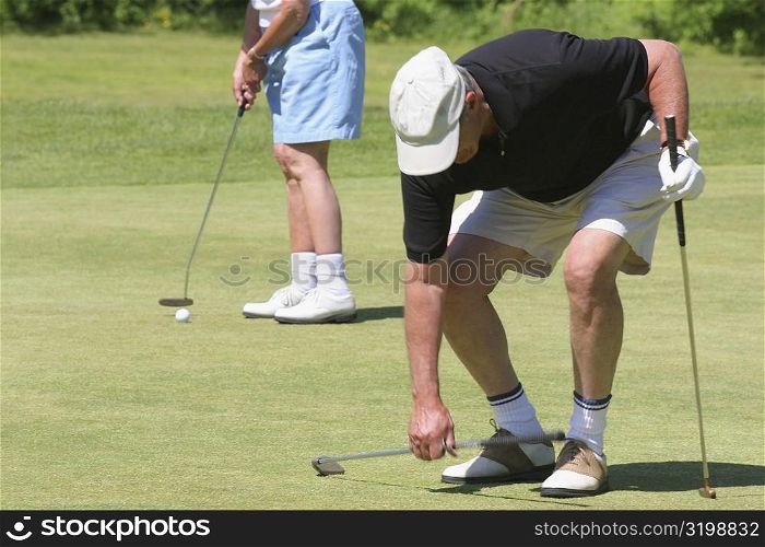 Two men playing golf on a golf course