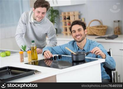 two men preparing a meal older man in wheelchair