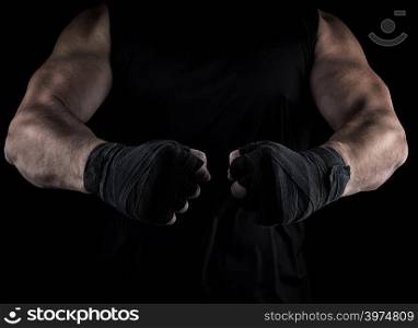 two men&rsquo;s hands wrapped in a black bandage, body parts in front of the torso, black background