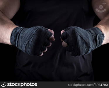 two men&rsquo;s hands wrapped in a black bandage, close up