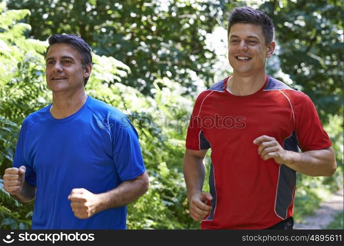 Two Men Running In Countryside Together