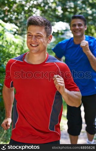 Two Men Running In Countryside Together