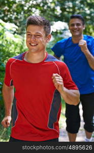 Two Men Running In Countryside Together