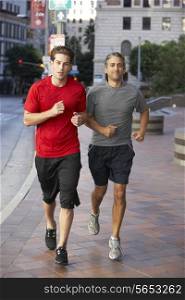 Two Men Running On Urban Street