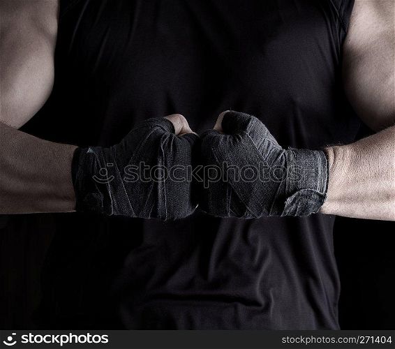 two men’s hands wrapped in a black bandage, close up