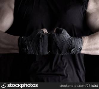 two men’s hands wrapped in a black bandage, close up