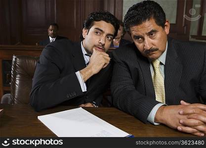 Two men sitting in court