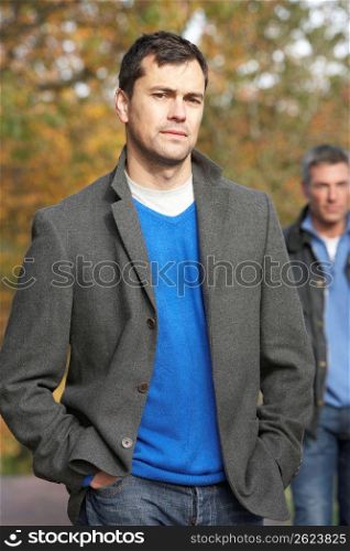 Two Men Standing Outside In Autumn Woodland