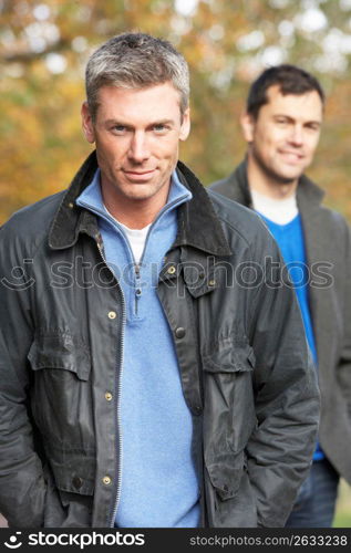 Two Men Standing Outside In Autumn Woodland