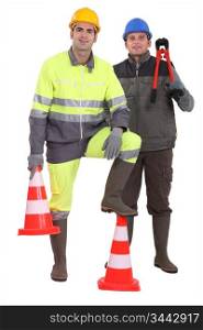 Two men stood with traffic cones