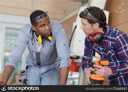 two men talking in workshop