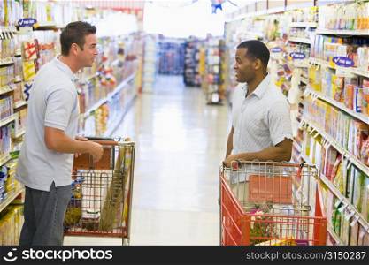 Two men talking to each other at a grocery store