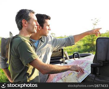 Two men with map one pointing