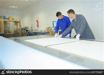 Two men working in printers