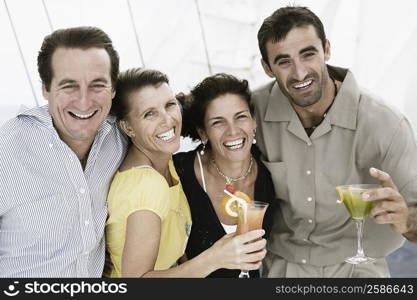 Two mid adult couples smiling together